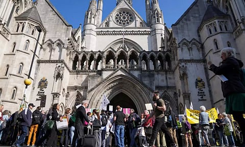 People attend a protest outside the High Court on the day of the extradition hearing of Assange (REUTERS)