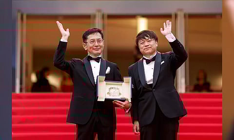 Goro Miyazaki and Kenichi Yoda with Studio Ghibli honorary Palme d’Or (Photo: AP)