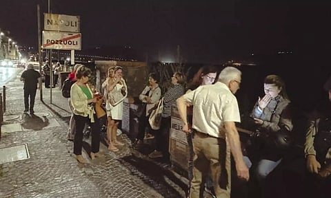 People gather in a street after an earthquake (AP)