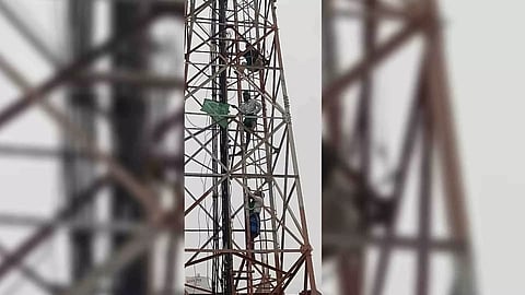 Farmers atop the cell phone tower on Woraiyur Main Road in Tiruchy on Wednesday