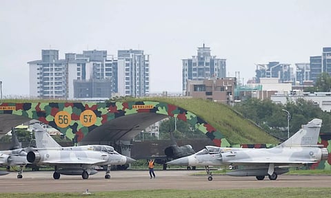 A ground staff gestures to Taiwan Air Force Mirage 2000-5 aircraft preparing to take off at Hsinchu Air Base (Reuters)
