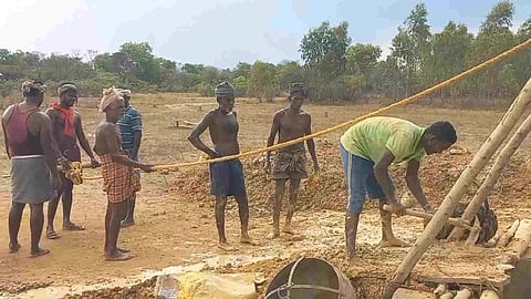 Villagers involved in desilting work in a well in Ariyalur on Friday