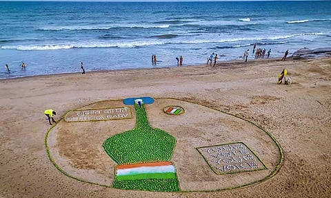 Renowed sand artist Sudarsan Pattnaik creates a sand sculpture to spread voting awareness with the message 'Chunab Ka Parba, Desh ka Garv', at Puri beach
