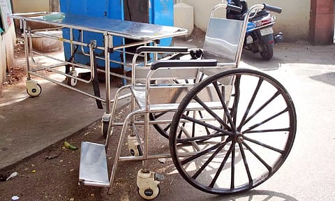 Stretcher and wheelchair kept at the entrance of District Headquarters Hospital in Erode 