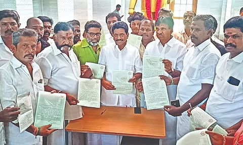 Farmers hold letters addressed to PM Narendra Modi at Col Pennycuick Memorial in Theni district on Wednesday