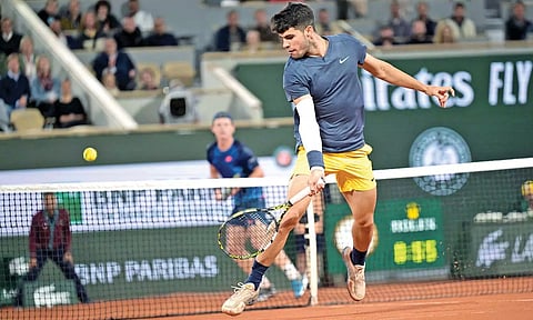 Carlos Alcaraz returns a shot during his match against Jesper de Jong