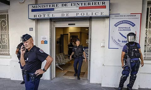  Police wait for the arrival of French President Emmanuel Macron at the central police station in Noumea