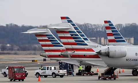 Grounds crews work around American Airlines aircraft at Reagan National Airport in Arlington (Photo: Reuters)