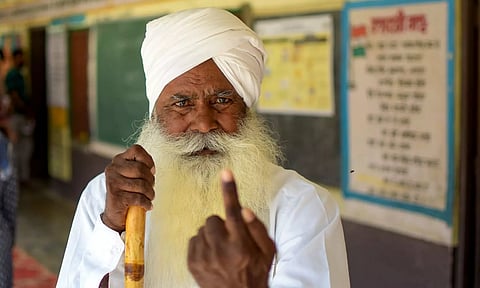 A voter shows his finger marked with indelible ink after casting vote for the last phase of Lok Sabha elections, in Amritsar (PTI)