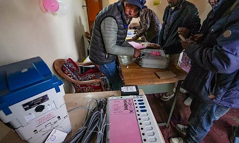 Election officials seal an Electronic Voting Machine at Tashigang (PTI)