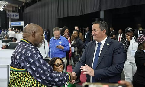 Leader of the main opposition Democratic Alliance John Steenhuisen, right, shakes hands with ANC's Chairman