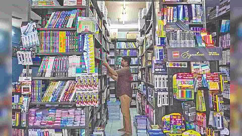 A stationery shop keeper awaits customers