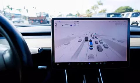 A Tesla Model 3 vehicle drives using FSD (Full Self-Driving) (Reuters)