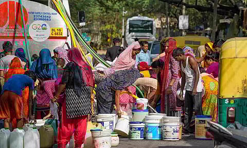 Residents fill water from a tanker amid water crisis, at the Vivekanand Camp, Chanakyapuri area, in New Delhi