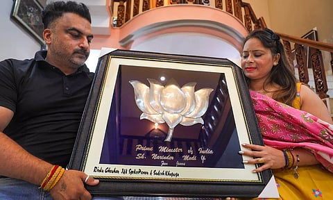 Rinku Chauhan, a jeweler from Jammu, shows his hand-made lotus flower, made of pure silver, which he wants to present to Prime Minister-designate Narendra Modi (PTI)