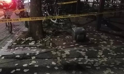 The trash from a balloon presumably sent by North Korea near the police tape, in Seoul, South Korea (AP)