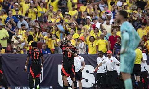 Colombia midfielder Jorge Carrascal, center rear, celebrates with Richard Rios (6) after a goal against the United States during the second half of an international friendly soccer match