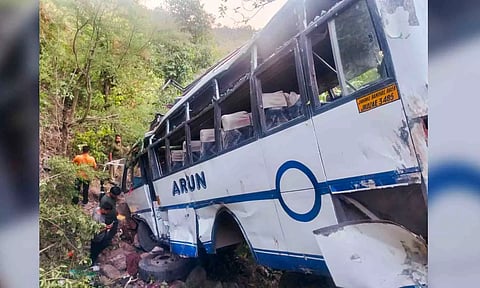 The damaged bus after it plunged into a gorge following an alleged attack by suspected terrorists (PTI)