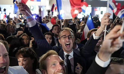 Supporters of French far-right National Rally react at the party election night headquarters 