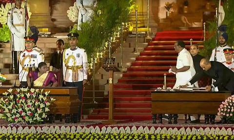 A feline animal seen walking, background top, as BJP MP Durga Das Uikey greets President Droupadi Murmu after completing the oath procedure, at Rashtrapati Bhavan (PTI)
