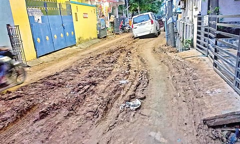 A four-wheeler stuck in the muddy road on 12th street of Balaji Nagar