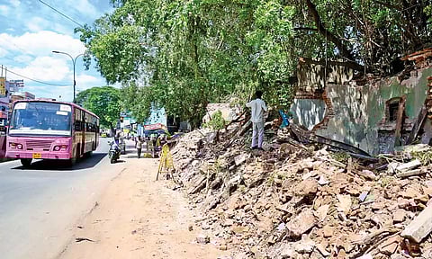 The debris of demolished buildings lying beside the road on the stretch from Harrington Road junction to Aminjikarai Signal