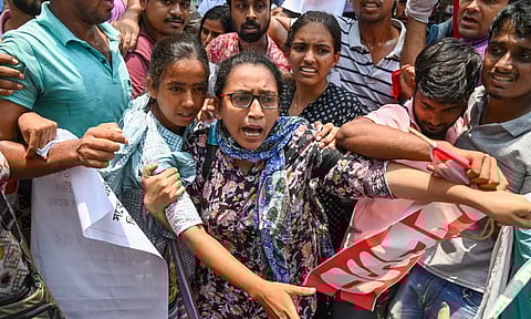 Detained members of AIDSO shout slogans during their protest against the alleged irregularities in NEET-UG entrance exam result-2024 (PTI)
