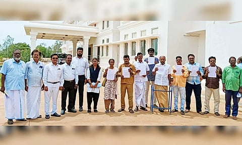 Transport employees display their petitions at Thanjavur SP office on Thursday