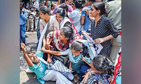 Members of AIDSO shout slogans during their protest against the alleged irregularities in NEET-UG-2024, at Salt Lake area in Kolkata