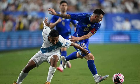 Lionel Messi gets past defender Jose Ardon during the match