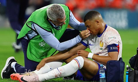 Kylian Mbappe receives medical attention after sustaining an injury