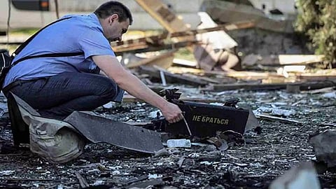 A war crimes prosecutor works at a site of a Russian drone attack, amid Russia's attack on Ukraine, on the outskirts of Lviv, Ukraine June 19, 2024 