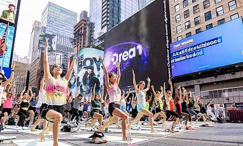 People participate in a mass yoga session at Times Square organised by the Consulate General of India