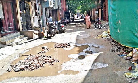Damaged road on Arumugam St where sewage stagnates all the time
