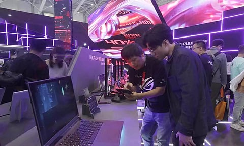Visitors review new computer products during the Computex Taipei exhibition, one of the world's largest computer and technology expos (AP)
