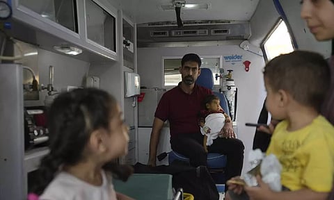 Palestinian children with their relatives before leaving to hospital (AP) 