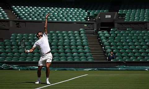Carlos Alcaraz takes part in a warm-up session at the All England Lawn Tennis Club