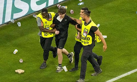 A fan intruder being taken away from the Stadium (AP)