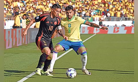 Colombia's James Rodriguez and Brazil's Lucas Paqueta vie for the ball