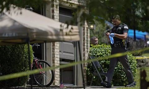 A member of Florence Police Department going to the house where shooting took place (AP)