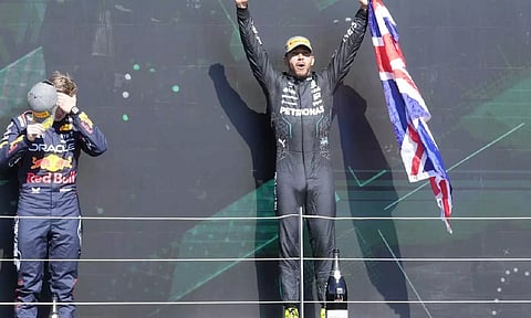 Lewis Hamilton celebrates on the podium after his win at British GP (AP)