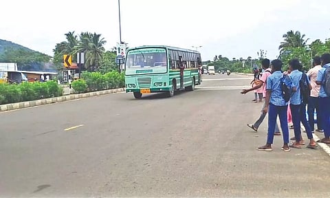 School students waiting at the Aapur bus stop as the SETC bus heading towards Chengalpattu moves past them without stopping