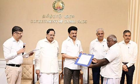 Chief Minister MK Stalin handing over orders to farmers and potters from Kancheepuram to take soil from water bodies at the Secretariat on Monday