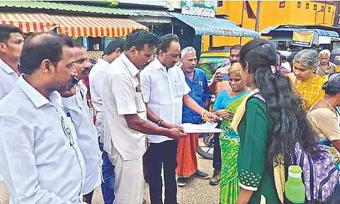 Residents and commuters signing a petition at the Palavanthangal railway station