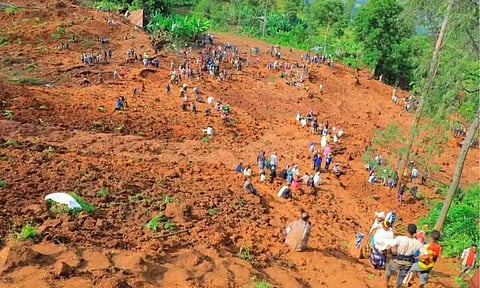Residents recover the dead bodies of victims of the landslide following heavy rains that buried people in Gofa zone, Southern Ethiopia (Reuters)