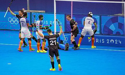 Paris: India's Abhishek (5) with Mandeep Singh (11) and New Zealand's players vie for the ball during the Pool B hockey match between India and New Zealand (PTI)