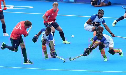 India's goalkeeper PR Sreejesh (16), captain Harmanpreet Singh (13) and Amit Rohidas (30) in action during the Hockey Mens Quarterfinal match between India and Great Britain (PTI)