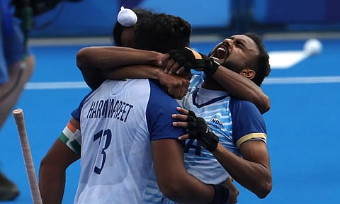 Hockey India players celebrate after their victory over Great Britain 