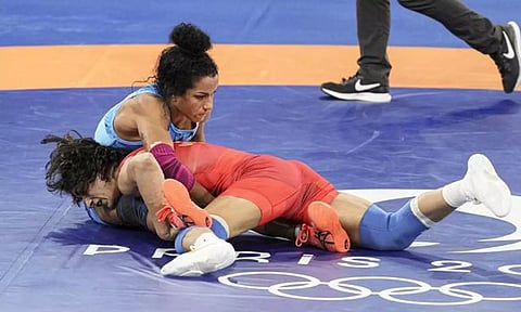 India’s Vinesh Phogat and Cuba’s Yusneylis Guzman Lopez (in blue) compete in the Women’s Freestyle 50kg semifinal on Tuesday (PTI)