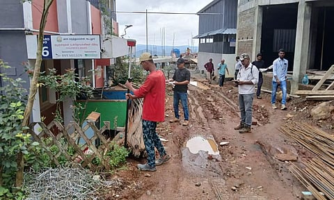GSI authorities inspect buildings that developed cracks after rains, in Kokkal area in Gudalur